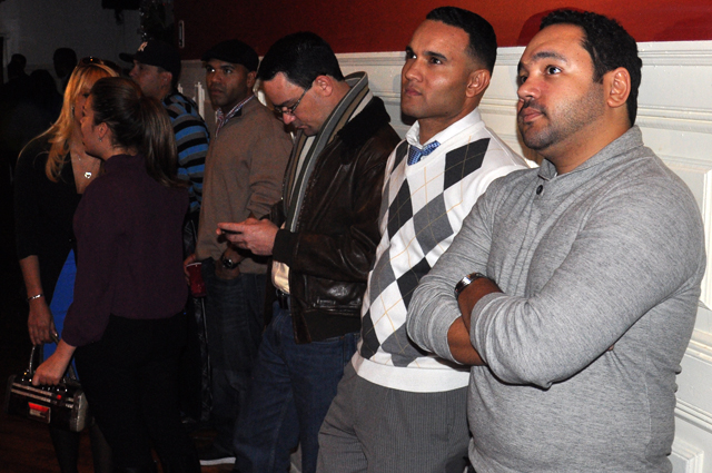 Carlos Sierra (center) and other attendees look on for election results. Carlos Sierra (center) and other attendees look on for election results.
